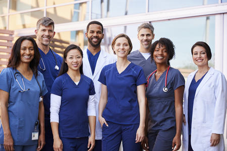 Image of eight diverse nurses standing in a group 